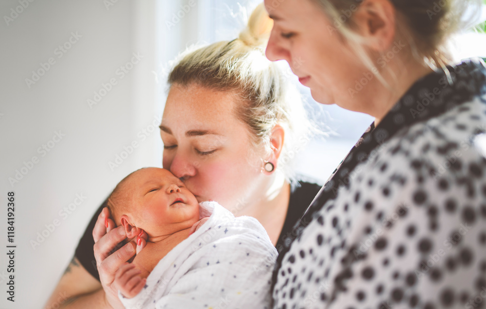 Women gay couple having fun with their baby daughter at home.