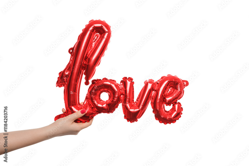 Fototapeta premium Hand holding a red balloon forming the word love against a plain background for celebration or decoration