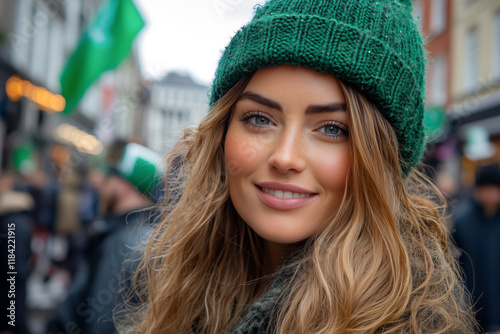 Portrait of a smiling woman with blond hair wearing a green ice cap in the city. Celebrating St. Patrick's Day photo