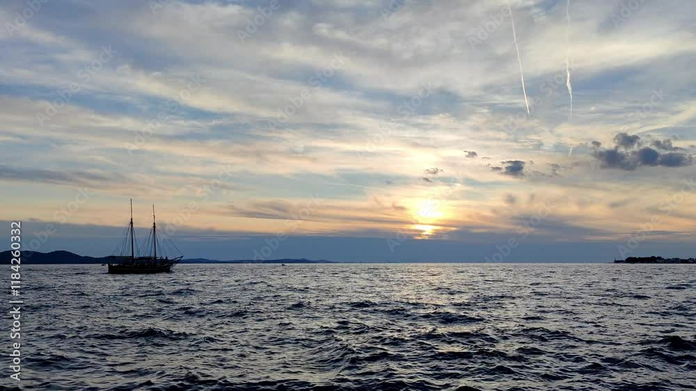 Majestic Sailing Vessel Gliding into Golden Sunset over Tranquil Ocean
Majestic Sailing Vessel Gliding into Golden Sunset over Tranquil Ocean