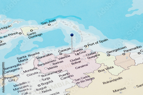 Macro photo of a blue pin needle into Puerto la Cruz city of Venezuela political map 