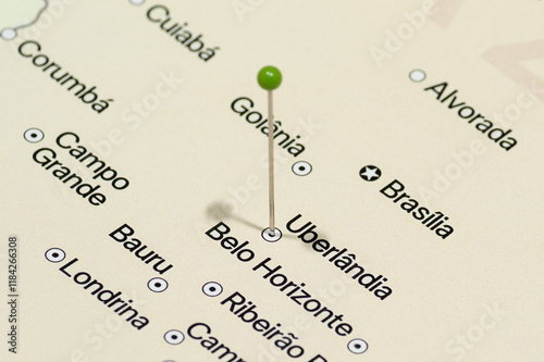 Macro photo of a Green pin needle into Uberlândia city of Brazil political map 