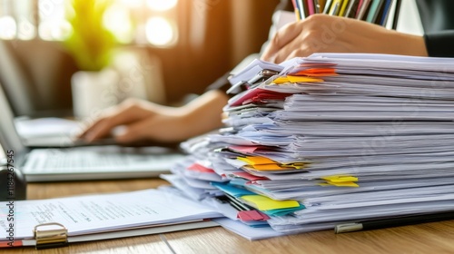 Overwhelmed by Papers at a Desk in Artificial Light