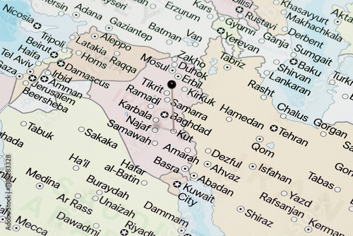 Macro photo of a black pin needle into Kut city of Iraq political map 