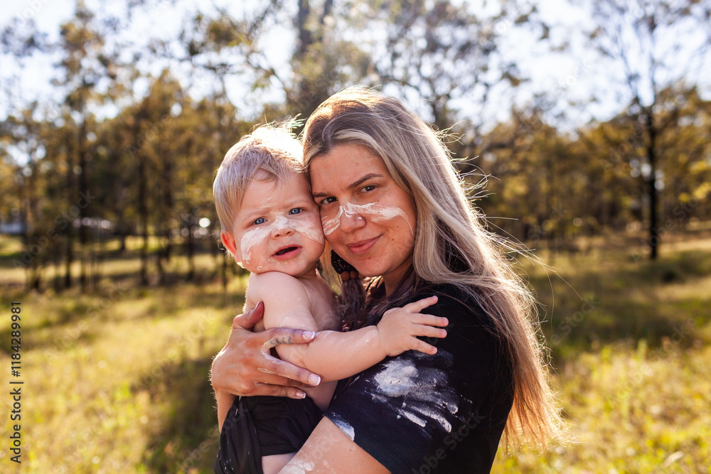 Cultural image of First nations Australian mother carrying son together on country Cultural image of First nations Australian mother carrying son together on country