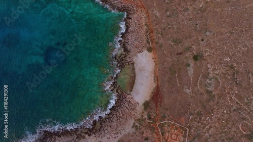 Aerial view of Vathi Beach at sunrise with the Mediterranean Sea and rugged cliffs, Lagia, Greece. photo