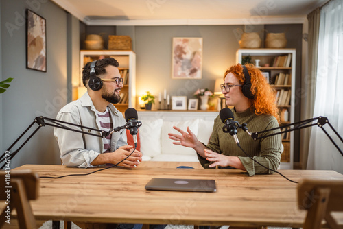 two radio hosts smile and enjoy while record podcast in studio photo