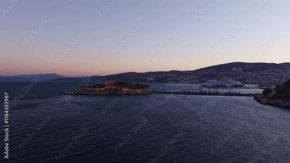 Aerial view of Kusadasi Castle and a cruiseship on the Aegean Sea at sunrise, Kusadasi, Turkey. Aerial view of Kusadasi Castle and a cruiseship on the Aegean Sea at sunrise, Kusadasi, Turkey.