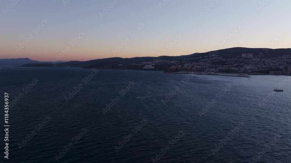 Aerial view of serene Aegean sea at sunrise with tranquil coastline and expansive horizon, Kusadasi, Turkey. Aerial view of serene Aegean sea at sunrise with tranquil coastline and expansive horizon, Kusadasi, Turkey.