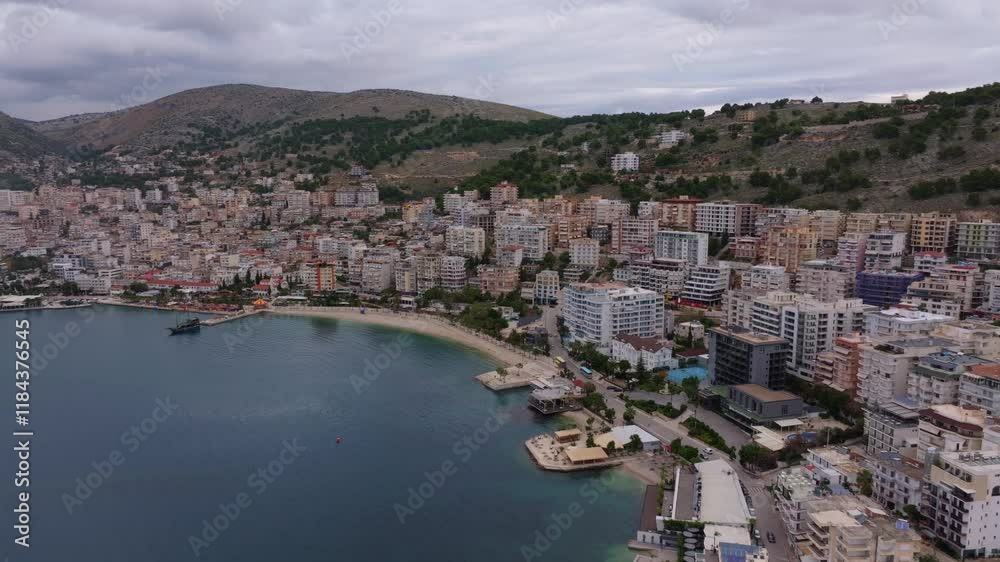 Aerial view of coastal town with modern buildings and scenic beach along the Mediterranean Sea, Saranda, Albania. Aerial view of coastal town with modern buildings and scenic beach along the Mediterranean Sea, Saranda, Albania.