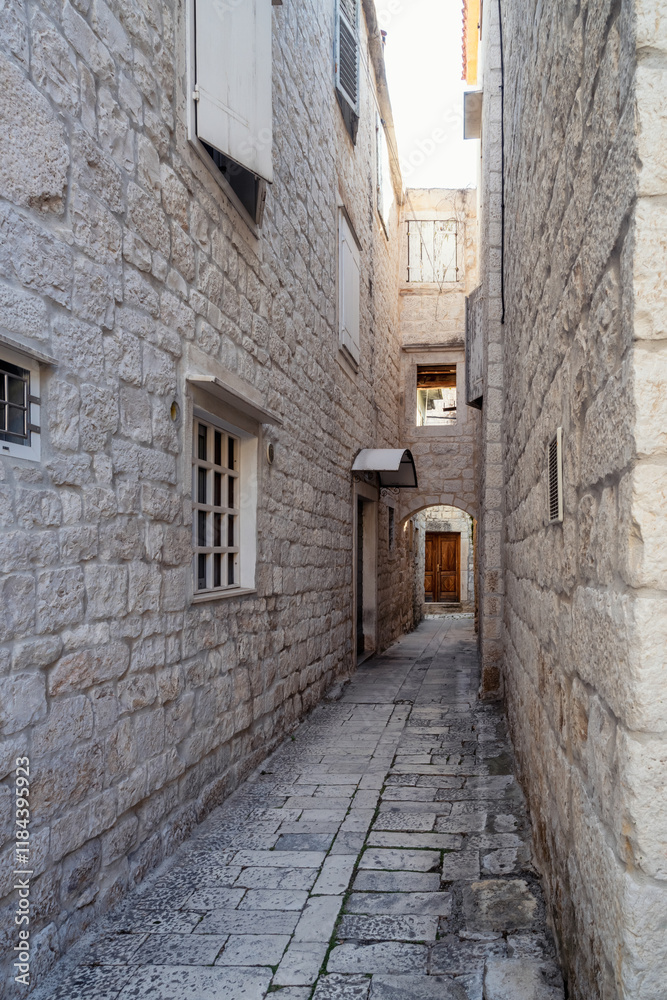 Morning walk along a romantic narrow street in the old town of Trogir on the Adriatic coast, Dalmatia, Croatia Morning walk along a romantic narrow street in the old town of Trogir on the Adriatic coast, Dalmatia, Croatia