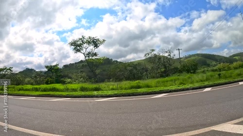 Car ride along the road on a sunny day with lots of clouds in the sky and intense car and truck traffic. During a holiday.