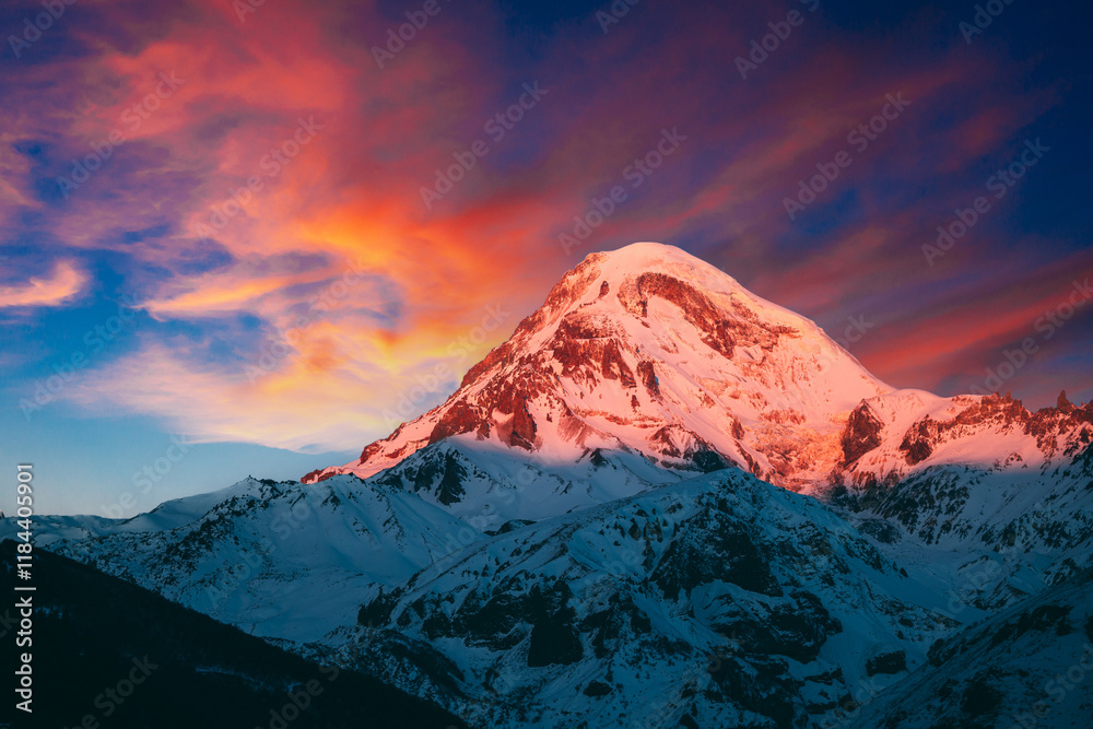 Georgia. Mount Kazbek Covered Snow In Winter Sunrise. Morning Dawn Colored Top Of Mountain In Pink-orange Colors. Awesome Winter Georgian Nature Landscape.