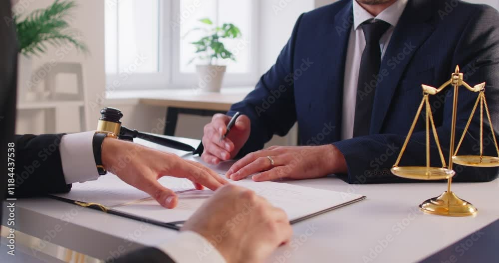 Close up shot of a lawyer or attorney working with a client during a meeting in an office, discussing legal documents, contract negotiations, and providing law services during conversation.
