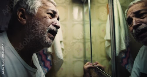 Man clutching mirror frame, face contorted in agony, eyes searching for answers in reflection, a dramatic exploration of inner conflict, anger, and helplessness