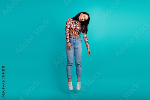 Full body portrait of nice young girl hang air isolated on turquoise color background photo