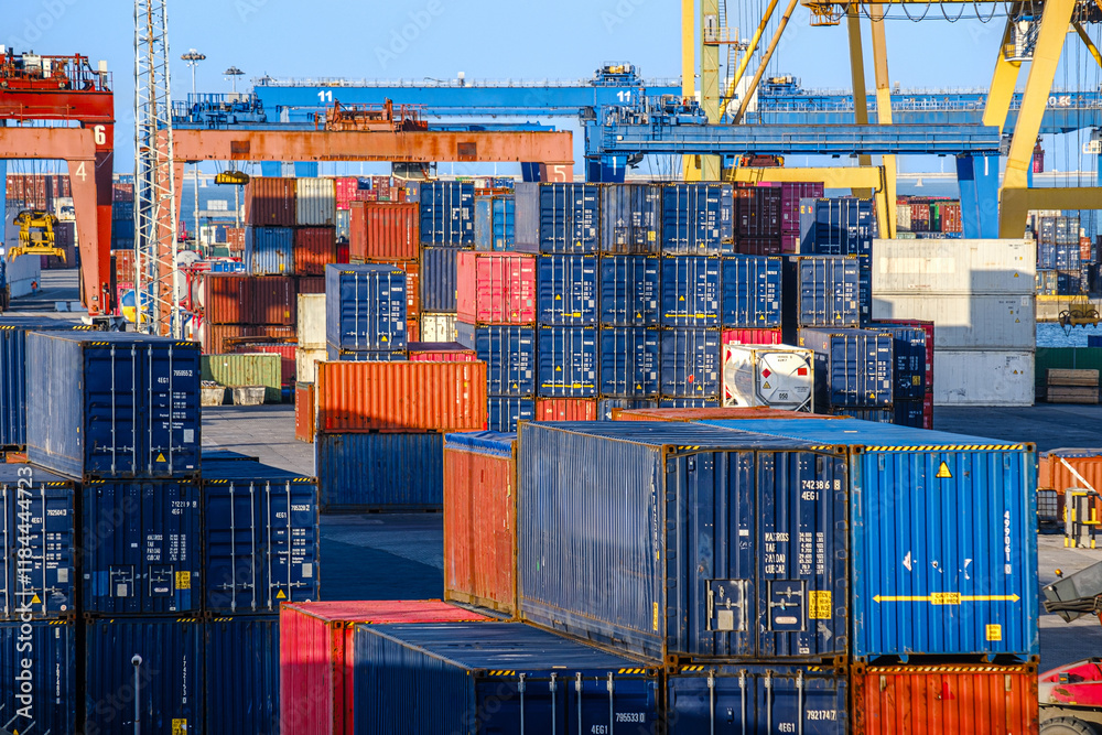 Cargo containers stacked at a busy shipping port during daylight