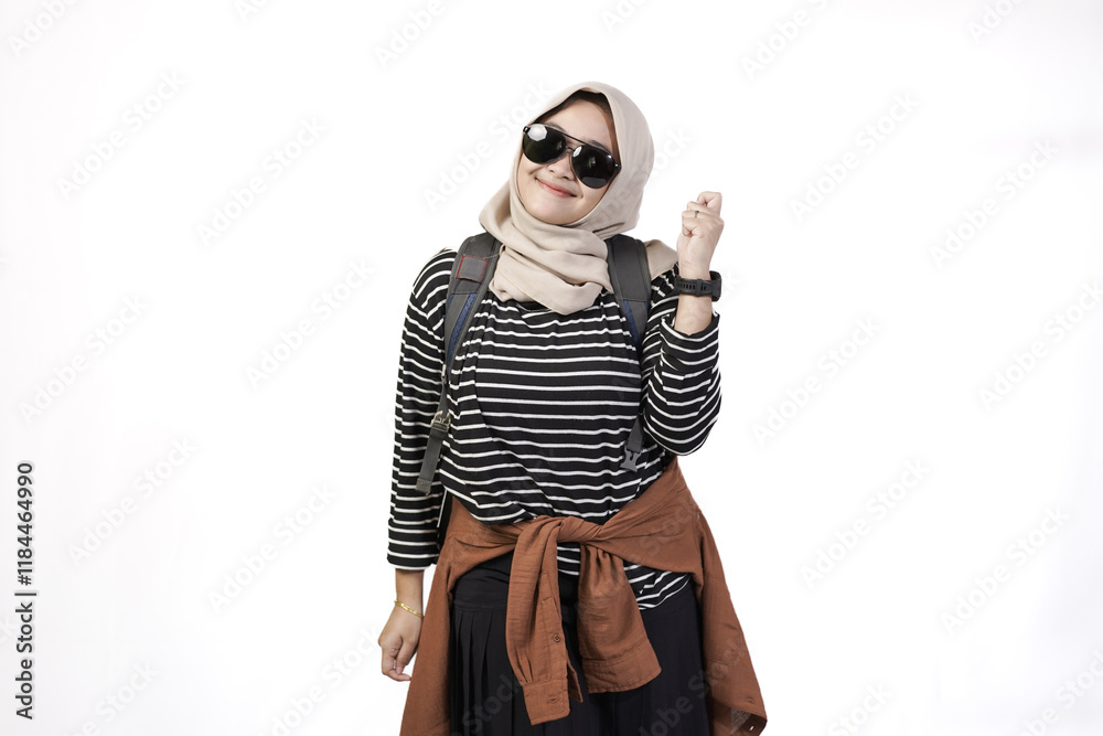Young Indonesian female backpacker wearing hijab looking excited and confident while traveling, travel concept, isolated on white background. Young Indonesian female backpacker wearing hijab looking excited and confident while traveling, travel concept, isolated on white background.