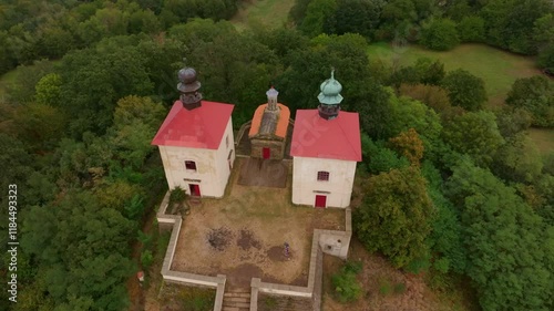 Aerial view of Calvary Ostre church surrounded by beautiful autumn woods and serene countryside, Ustek, Czech Republic. photo