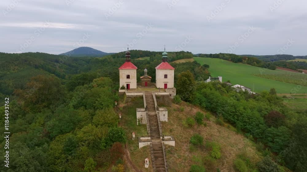 Aerial view of Calvary Ostre church surrounded by trees and hills, Ustek, Czech Republic. Aerial view of Calvary Ostre church surrounded by trees and hills, Ustek, Czech Republic.