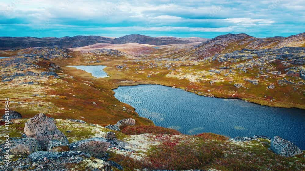 Tundra landscape with lake and colorful vegetation in Autumn. Russia, Teriberka Tundra landscape with lake and colorful vegetation in Autumn. Russia, Teriberka