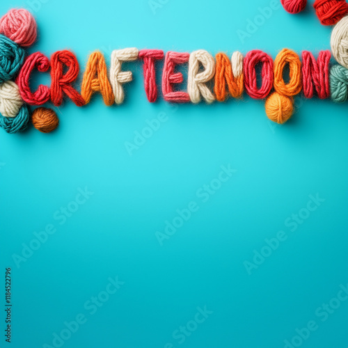 CRAFTERNOON knitted text with balls of wool on plain blue color studio background and text copy space photo