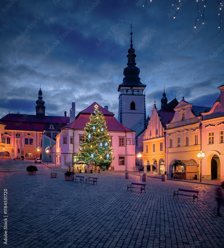 Fototapeta premium View of the pre-Christmas decorated Masaryk Square in Pelhřimov, illuminated Christmas tree