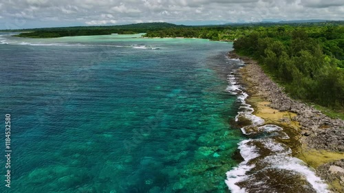 Aerial view of beautiful tropical coastline with serene ocean waves and lush forest, Shefa Province, Vanuatu. photo