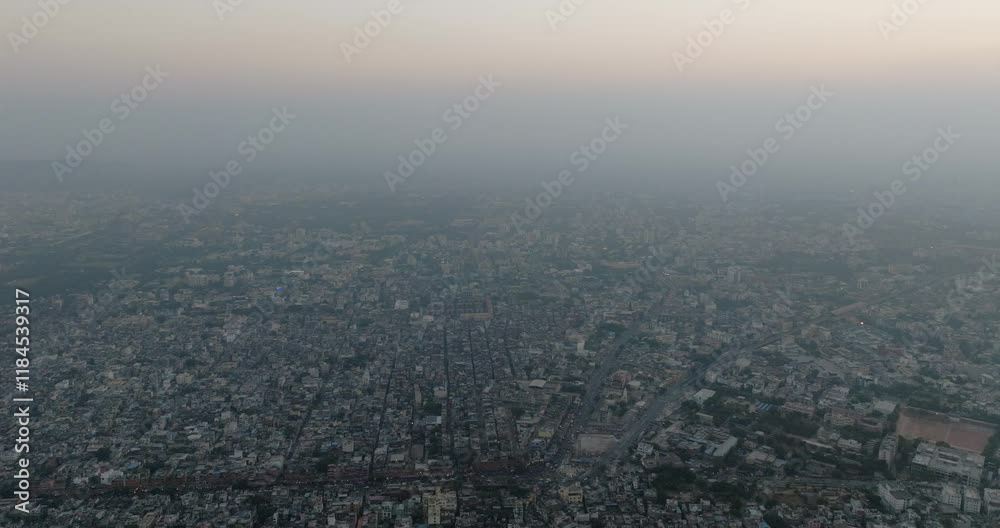Aerial view of a crowded urban skyline at dusk with dense buildings and rooftops, Sindhi Camp, Jaipur, India. Aerial view of a crowded urban skyline at dusk with dense buildings and rooftops, Sindhi Camp, Jaipur, India.