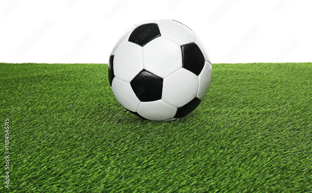 Fototapeta premium One soccer ball on green grass against white background. Sport equipment