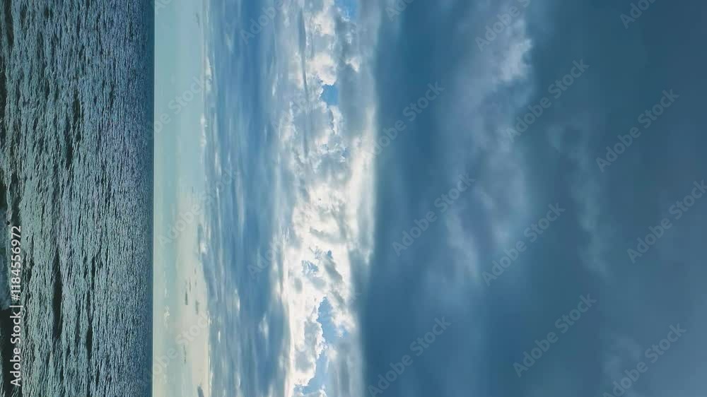 Vertical. Sea Blue Sky Black Gray White Rain Clouds in Sun Rays Horizon Slow Motion. Beautiful Bay Cloudy Storm Sky Waves Background. Planet, Vacation, Travel Tourism Ocean Beach Seascape Vertical. Sea Blue Sky Black Gray White Rain Clouds in Sun Rays Horizon Slow Motion. Beautiful Bay Cloudy Storm Sky Waves Background. Planet, Vacation, Travel Tourism Ocean Beach Seascape