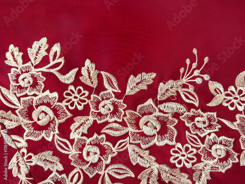 Close up of random flower and leaves illustration pattern drawn in gold color, with red background. Floral and foliage theme with red and gold color concept. Seamless texture. photo