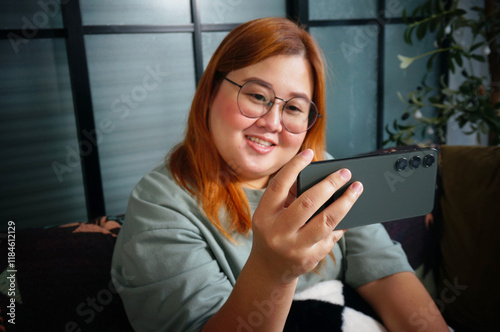 woman Work from home smiling Beautiful mature asian woman VDO call conference talk online on video call on laptop webcam with technology concept.