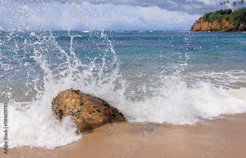 waves hitting a rock on the beach