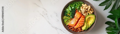 Fresh Salmon Bowl with Avocado, Greens, and Cashews on Marble Surface