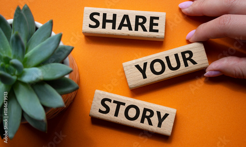 Share your story symbol. Wooden blocks with words Share your story. Beautiful orange background with succulent plant. Businessman hand. Business and Share your story concept. Copy space.