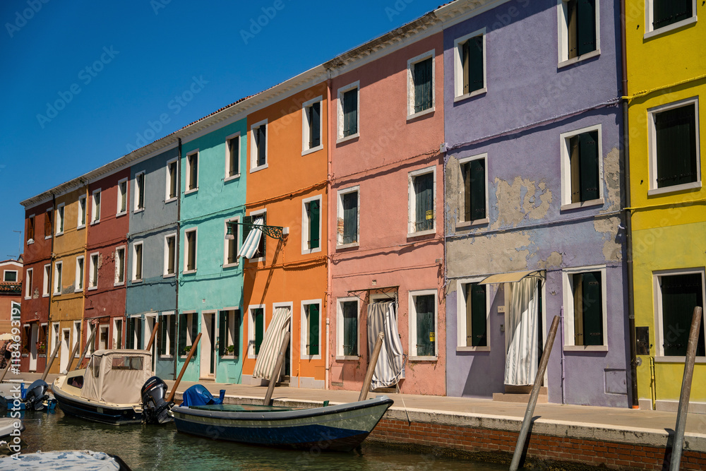 View of colorful houses along the canal with boats, Burano, Italy. View of colorful houses along the canal with boats, Burano, Italy.