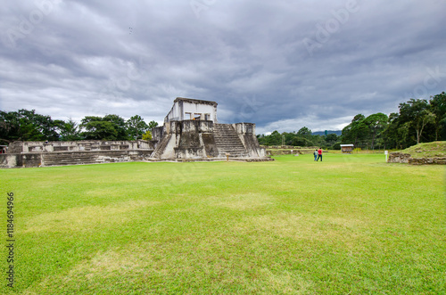 Wide view of the Mayan City of Zaculeu. Imposing pyramid-shaped buildings, surrounded by mountains close to the clouds. photo