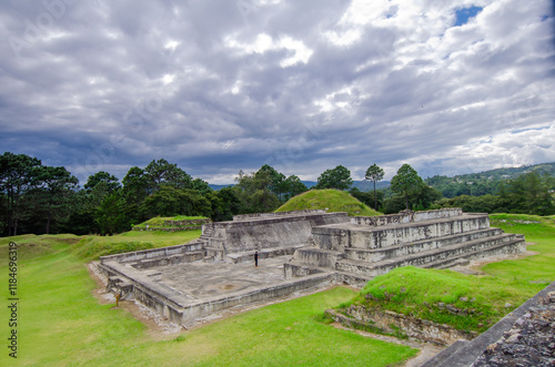 Wide view of the Mayan City of Zaculeu. Imposing pyramid-shaped buildings, surrounded by mountains close to the clouds. photo