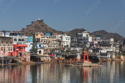 Pushkar, India - 14 December 2024: View of colorful buildings and a serene lake with reflections, Pushkar, Rajasthan, India. photo