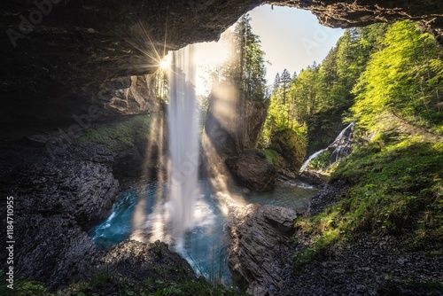 View of Berglistuber Wasserfall surrounded by serene forest and majestic rocks, Glarus Sud, Switzerland. photo