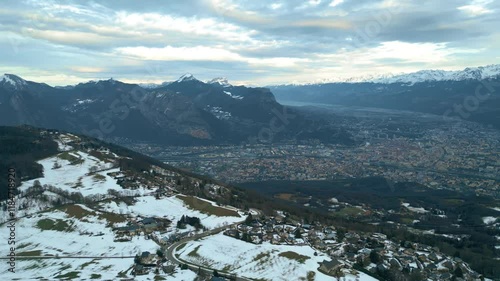 Aerial view of Grenoble and the Alps mountains on a cloudy winter day. Isere, France