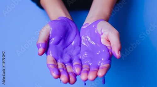 Sticky Purple Slime on Hands. A Conceptual Image for Relaxation and Beauty. A Fun Experiment for Kids into Oddly Satisfying Semi-Surreal ASMR Art