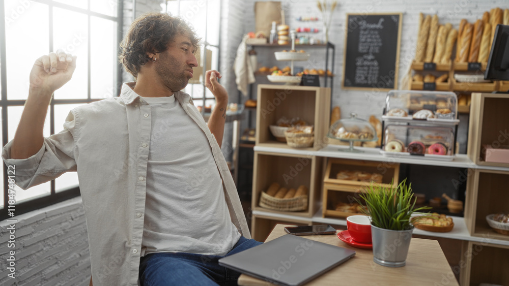 Young man stretching in a cozy bakery with assorted pastries and a coffee in the foreground Young man stretching in a cozy bakery with assorted pastries and a coffee in the foreground
