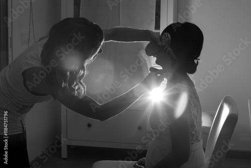 Bride getting makeup done with sunlight glare photo