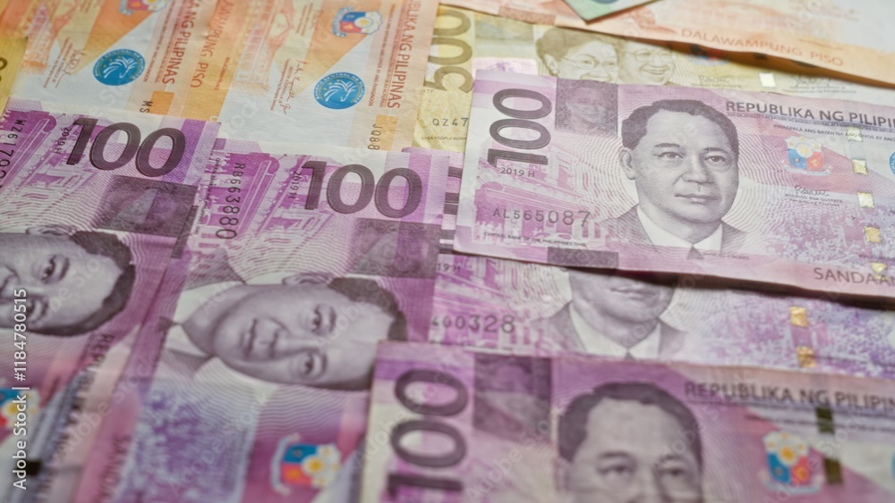 Obraz premium Philippine banknotes scattered, showcasing various denominations of pesos