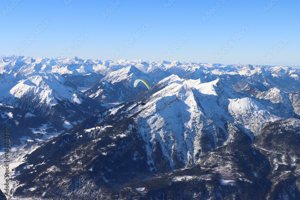 Fototapeta premium Flying over snow covered peaks