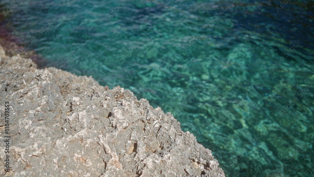 Rocky coastline at mallorca, spain featuring clear blue mediterranean water and rugged texture Rocky coastline at mallorca, spain featuring clear blue mediterranean water and rugged texture