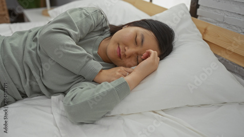 Wallpaper Mural Woman sleeping peacefully on a bed in a cozy bedroom, showcasing serene indoor tranquility and nighttime relaxation, highlighted by soft light and a comfortable setting. Torontodigital.ca