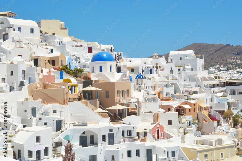 Oia village on Santorini island, Greece. Traditional and famous houses and churches with blue domes over the Caldera, Cyclades islands Aegean sea. Oia village on Santorini island, Greece. Traditional and famous houses and churches with blue domes over the Caldera, Cyclades islands Aegean sea.